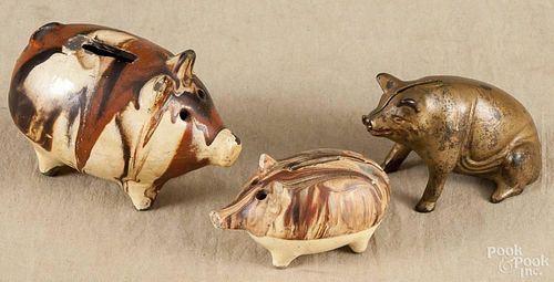 Two Continental earthenware pig banks, 19th c., together with a cast iron pig still bank