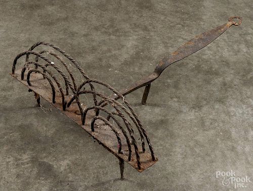Wrought iron rotating toaster, 19th c., with a heart cutout handle, 18 3/4'' l.