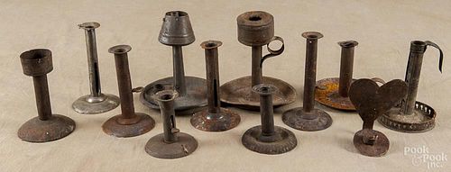 Tin and iron lighting, 19th c., to include hogscraper candlesticks, a heart-shaped sconce, etc.