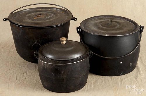 Three cast iron gypsy pots, 19th c., with tin lids, largest - 8 1/2'' h., 11'' w.