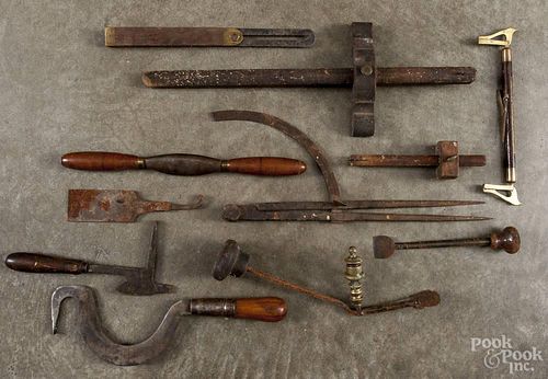 Group of antique iron, wood, and brass tools.