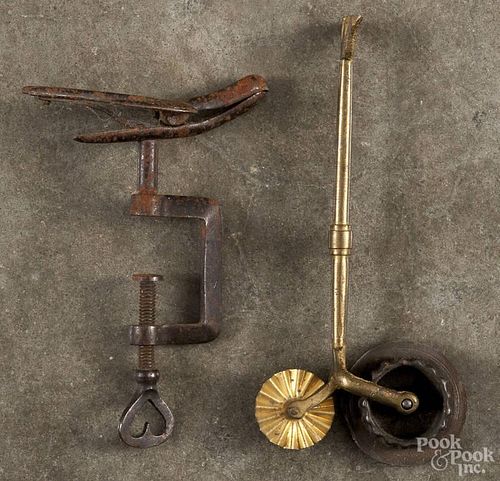Iron bird-form sewing clamp, 19th c., 4 3/4'' l., together with a brass jagging wheel, 5 3/4'' l.