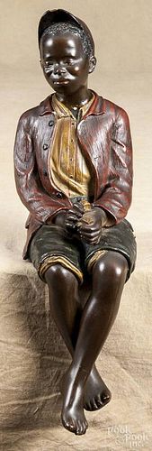 Painted plaster figure of an African American boy with dice, 20th c., 17 1/2'' h.