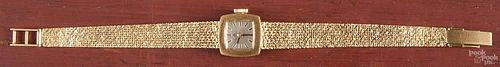 Ladies Bucherer 18K yellow gold wrist watch, with a tapered gold mesh band, 19.0dwt.