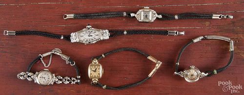 Five ladies wrist watches, to include gold cases with black cord bands.