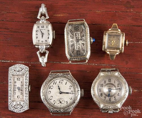 Six ladies wrist watches, no bands, to include gold cases, platinum covered with diamonds