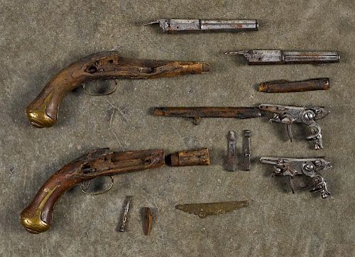 Pair of small flintlock parts pistols, to include two barrels, locks and broken stocks with brass