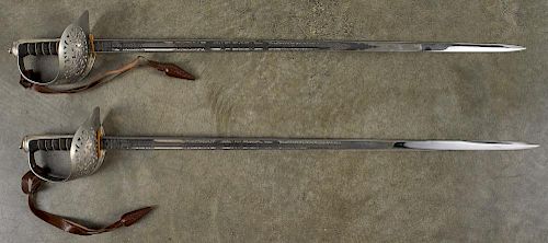 Two modern Wilkinson swords, with faux ray wrapped grips, acid etched blades, and leather cone por