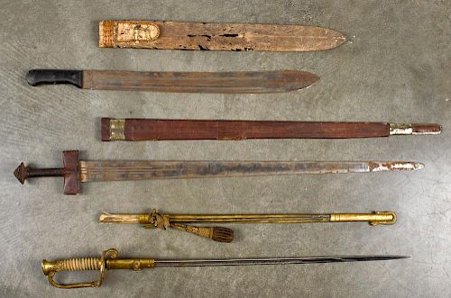 Three edged weapons, to include a US Navy officers dress sword with etched blade, wire wrapped ray