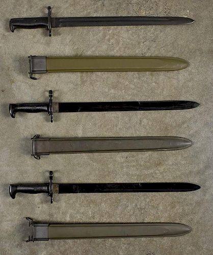 Two US Navy MK I training bayonets and scabbards