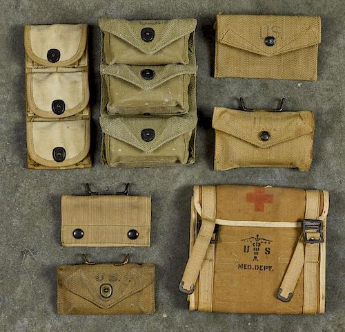 Group of WW I and WW II first aid supplies in canvas bags, to include one with six original tins.