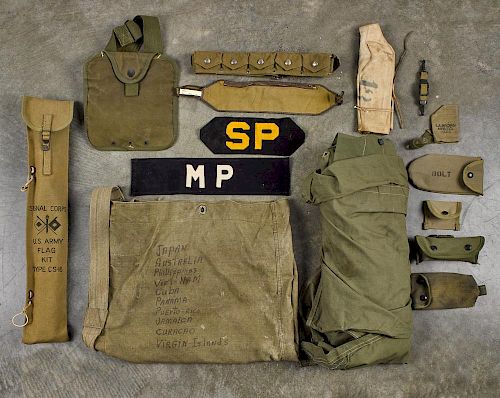 Group of WW II soldier accessories, to include a canvas shelter with wood stakes, several pouches,