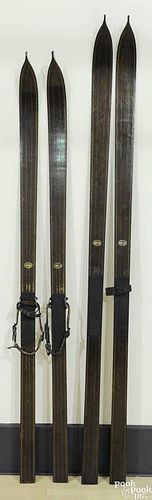 Two pairs of antique Northland Ski Co. skis, 89'' l. and 82 1/2'' l.