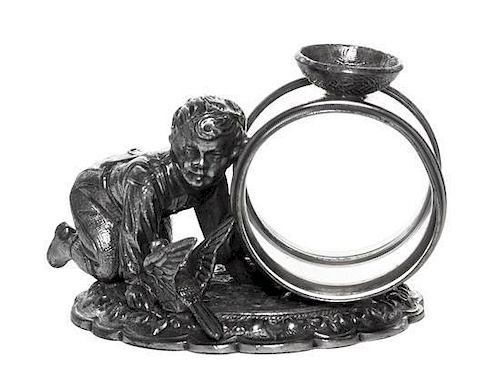 An American Silver-Plate Figural Napkin Ring with a Child and Bird, Late 19th Century, the shaped oval base with scroll border s
