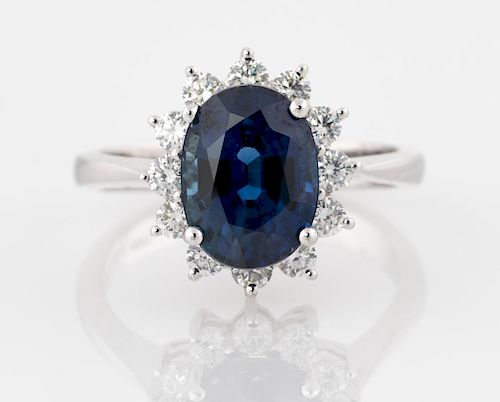 A WHITE GOLD RING WITH AN OVAL SAPPHIRE AND DIAMONDS ACCOMPANIED BY A CERTIFICATE
