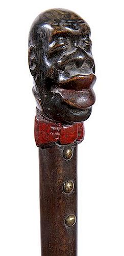304. Riverboat Folk-Art Cane – Ca. 1900 – A carved and painted one-piece cane with an over-exaggerated African American c