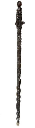 339. Folk-Art Ball and Cage Cane – Ca. 1900 – A one-piece black varnished cane with a gentleman’s bust atop, a bell and