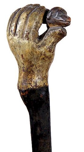 344. Dog in Hand Folk-Art Cane – Ca. 1870 – A one piece carved branch with a painted hand holding a dog’s head, varnish