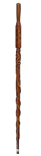 381. Lodge Folk-Art Cane – Ca. 1880 – A carved one-piece oak shaft with a walnut simple handle, various high-relief carvi