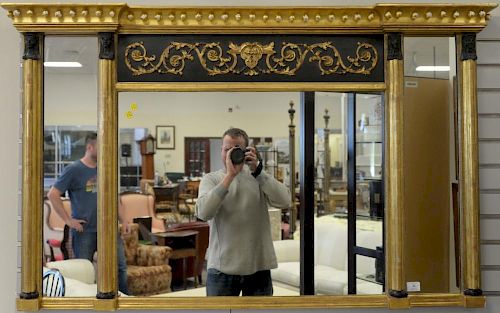 Federal style three part mirror, gilt and black painted with Pharaoh busts. 35" x 56"  Property from Credit Suisse's American