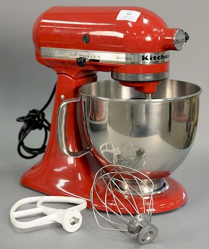 Red KitchenAid artisan mixer with attachments.