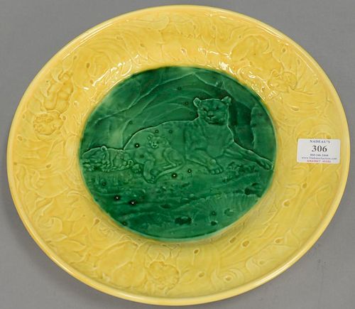 Large Wedgwood Majolica glazed plate having yellow leaf pattern and putty border around green glazed center having lioness wi