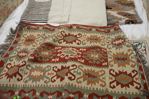 Group of seven Indian blankets and flatweave rugs.