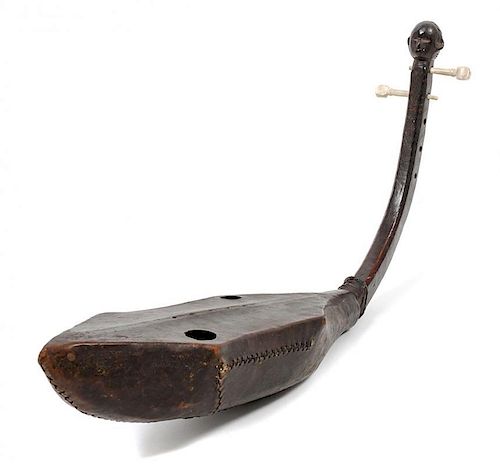 A Ngbaka Harp, DEMOCRATIC REPUBLIC OF CONGO, FIRST HALF OF 20TH CENTURY, with a body wrapped in leather that has been stiched