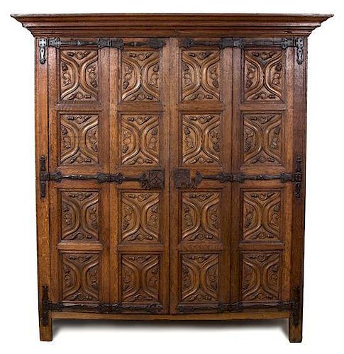 A Northern European Gothic Carved Oak Armoire Height 86 1/2 x length 51 1/2 x depth 32 1/2 inches.