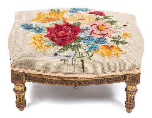 A Louis XV Style Giltwood and Needlepoint Foot Stool Height 6 x width 13 1/2 x depth 11 1/2 inches.