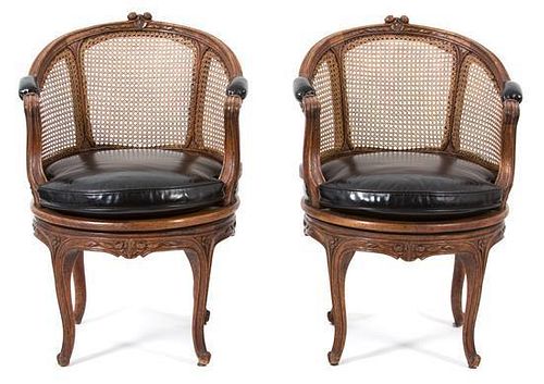 A Pair of Louis XV Style Mahogany Barrel Back Bergeres Height 33 x diameter 21 inches.