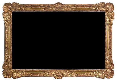 A Monumental Carved Giltwood Framed Mirror Height 54 1/2 x width 81 inches.