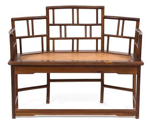 A Chinese Hardwood and Rattan Bench Height 34 x width 44 x depth 20 inches.