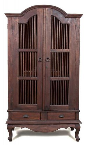A Javanese Teak Two Door Cabinet Height 78 x width 40 1/2 x depth 23 inches.
