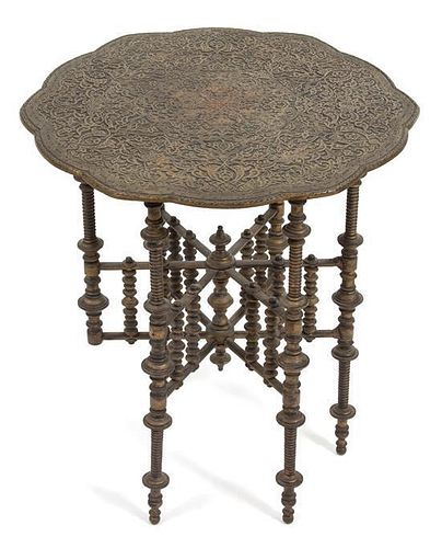 An Indian Embossed Bronze Tray Top Table Height 21 x diameter 18 inches.