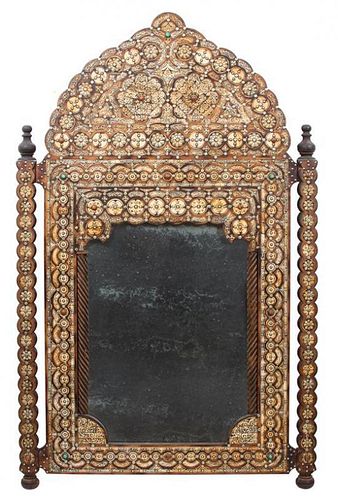 A Syrian Carved and Mother-of-Pearl Inlaid Mirror Height 67 x width 43 inches.