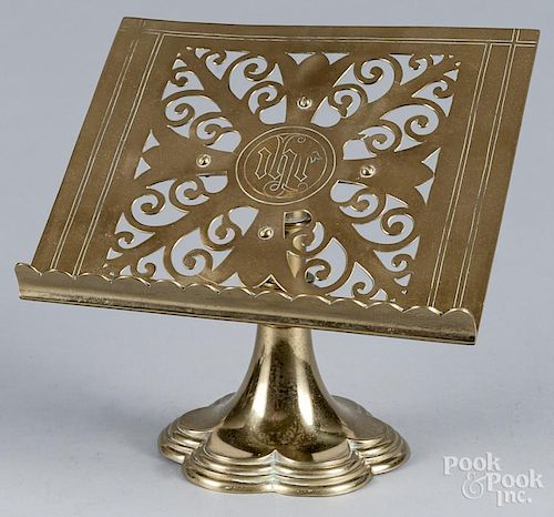 Five brass desk accessories, to include a letter opener, a book stand, etc.