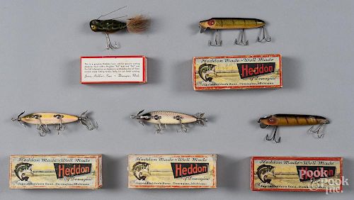Five Heddon wood fishing lures in boxes, to include two 150 Dowagiac minnow, two Vamps, and a Weedle
