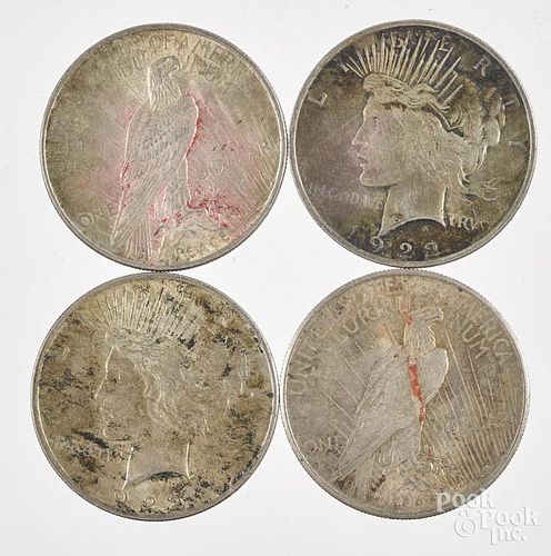 Four Peace silver dollars, to include three 1922 and one 1925.