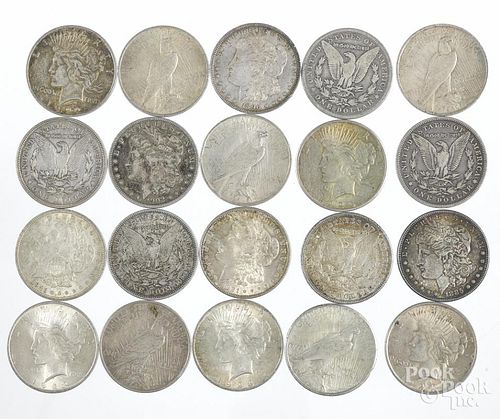 Ten Morgan silver dollars and ten Peace dollars.