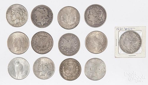 Seven Morgan silver dollars and six Peace dollars.
