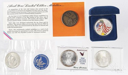 Three US silver eagles, 1991, 1995, and a colorized 2001, together with a 1971 silver Ike dollar and
