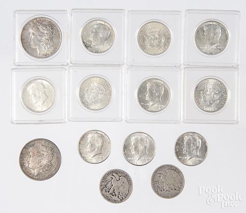 Two Morgan silver dollars, 1897 and 1883 O, together with ten 1964 Kennedy silver half dollars, a 19