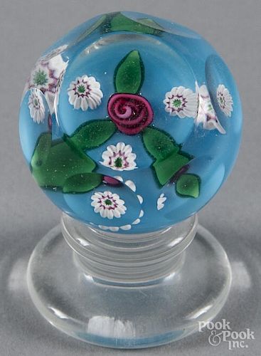 Charles Kaziun Jr., red coiled rose pedestal paperweight, with three millefiori canes on a blue grou