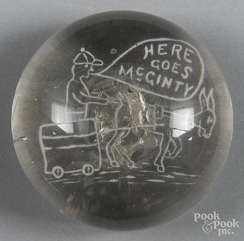 White frit paperweight, depicting a donkey pulling a cart and a man, inscribed Here Goes McGinty,