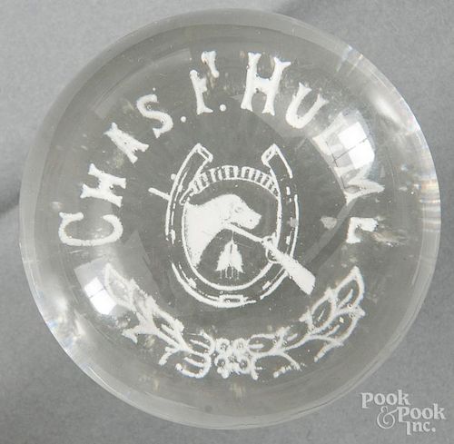 White frit hunter's paperweight, decorated with a horseshoe, hunting dog and rifle, inscribed with a
