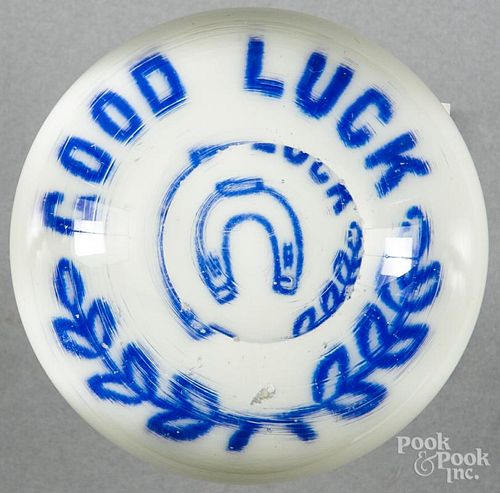 Blue enamel Good Luck paperweight on a white ground, with a horseshoe and top facet, 3 1/8'' dia.