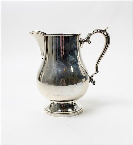 * An American Silver Water Pitcher, M. Fred Hirsch Co., Jersey City, NJ, of baluster form, raised on a circular foot.