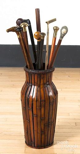 Collection of canes, together with a rattan stand.