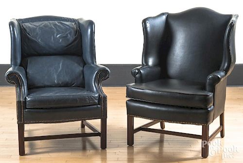 Two leather upholstered wing chairs.